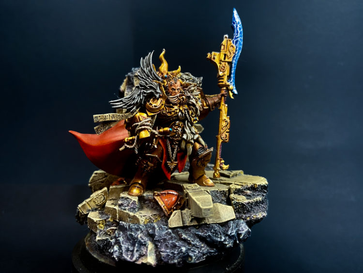 Constantine Valdor standing on a rock holding a spear